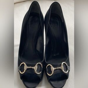 Gucci high-heeled shoes with horseshoe buckle on front. 
Black size 8.5.